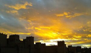 In Marrakech, as the day draws to a close, the sunset casts a warm golden glow over the palm trees