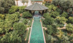 Lush garden path with green tiles and green plants at Le Jardin Secret Marrakech
