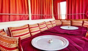 Interior view of an arabian Riad Tent with traditional pillows, carpet and silver plates, Marrakech, Morocco