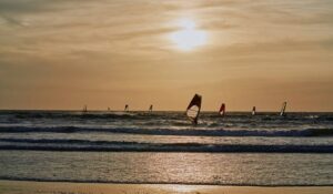 Surfers at the beach at Essaouira city at sunset