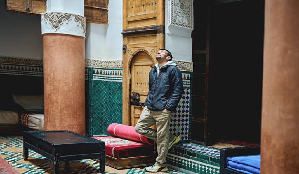 Man standing in Moroccan riad courtyard 